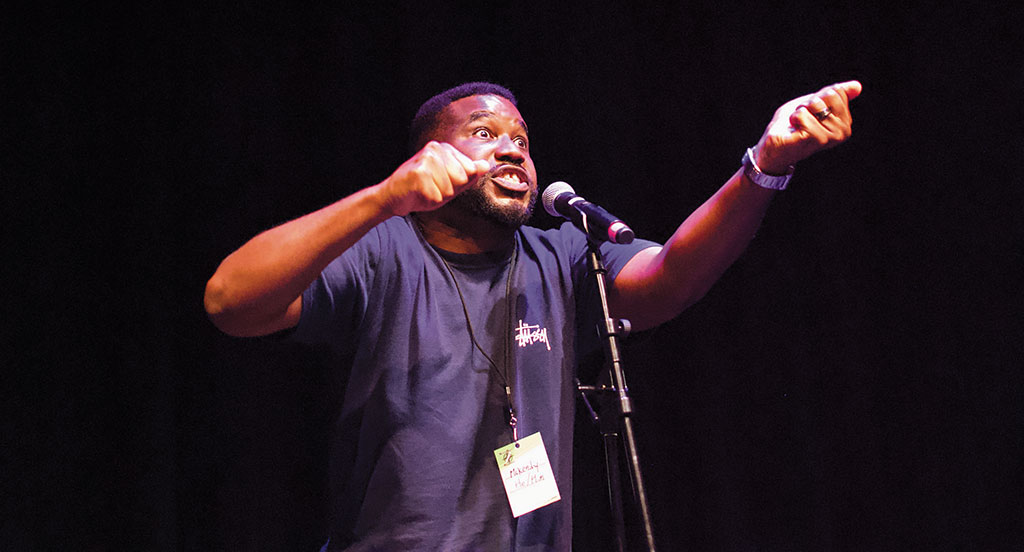 Mckendy Fils-Aimé performs at the 2024 NorthBeast Regional Poetry Slam, a tournament where 16 poetry slam teams from all over the northeast and beyond compete against one another. Photo: Leah Klein.