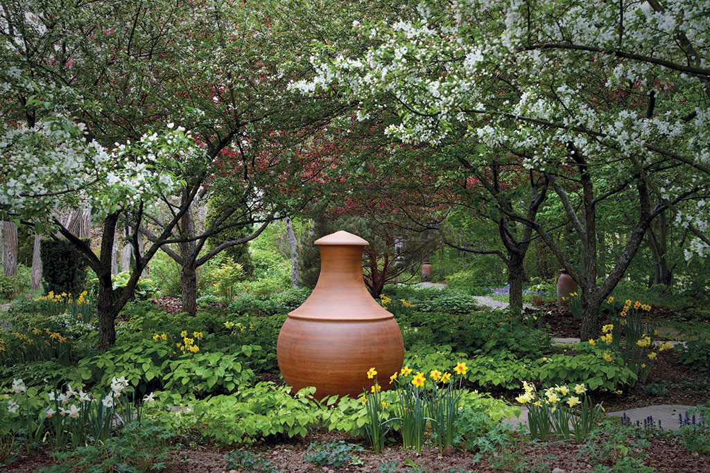 Naomi Ferenczy, large globe vessel in spring at Hayward Gardens in Putney, Vermont. The photographed Monumental Globe Vase is hand thrown, high fire stoneware. It is 58" tall by 38" wide. Photo: Sean Reid.