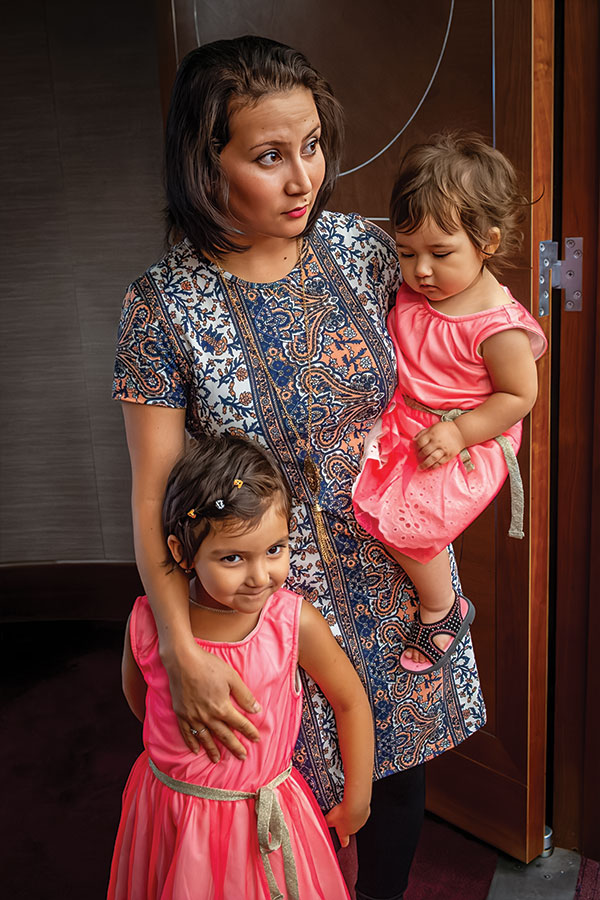 Becky Field, FieldWorkPhotos, An Afghan mother and her two girls wait for her husband to complete his citizenship ceremony, 2017, photograph. At The Gallery at WREN.